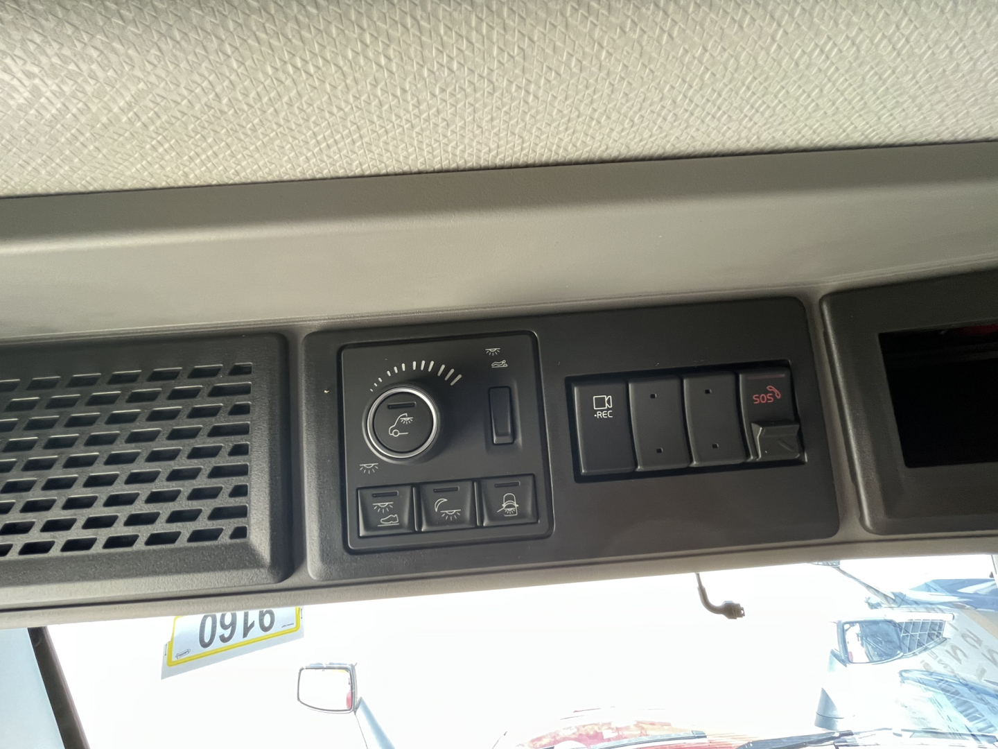 Volvo VNL64T840 sleeper cab dashboard panel showing overhead controls and a circular gauge with multiple buttons.