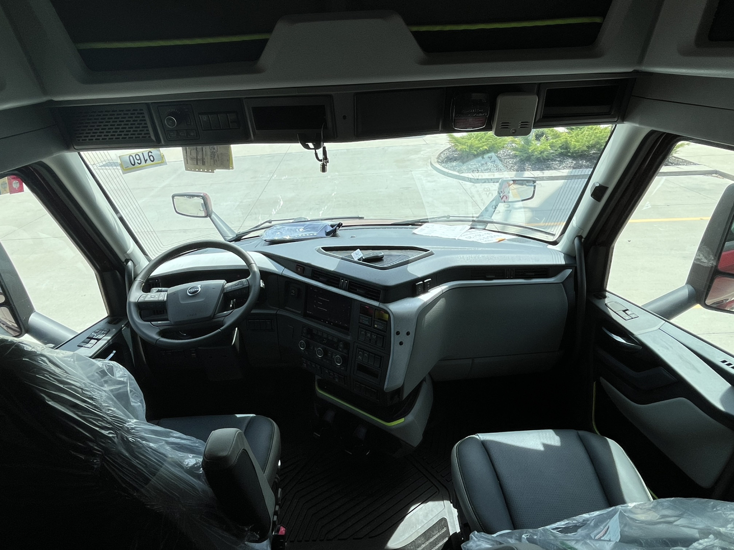 Volvo VNL64T840 truck interior showing steering wheel, dashboard, and driver's seat.