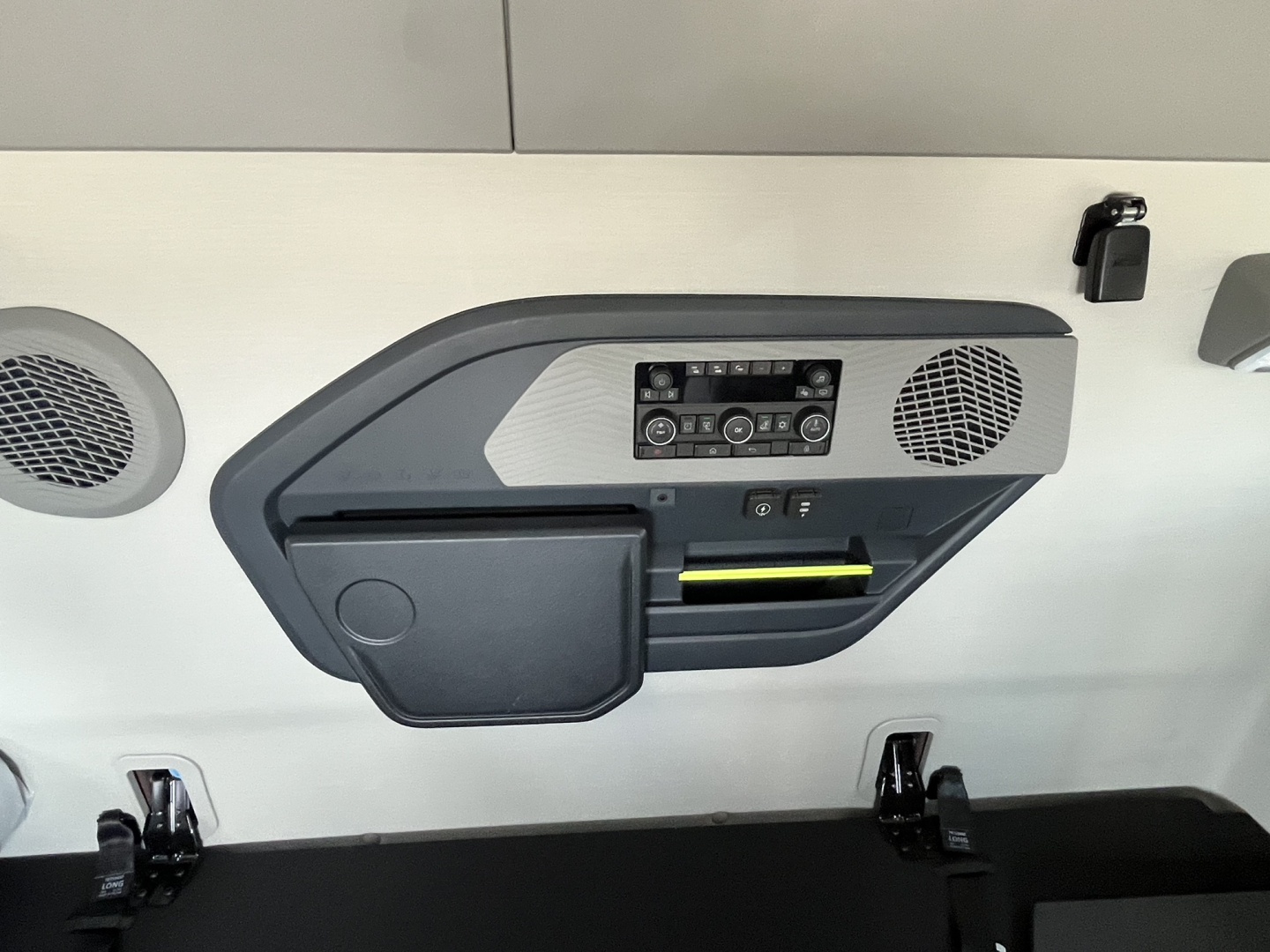 Volvo VNL64T840 sleeper cab interior panel with control panel, speakers, and a yellow-handled storage slot.