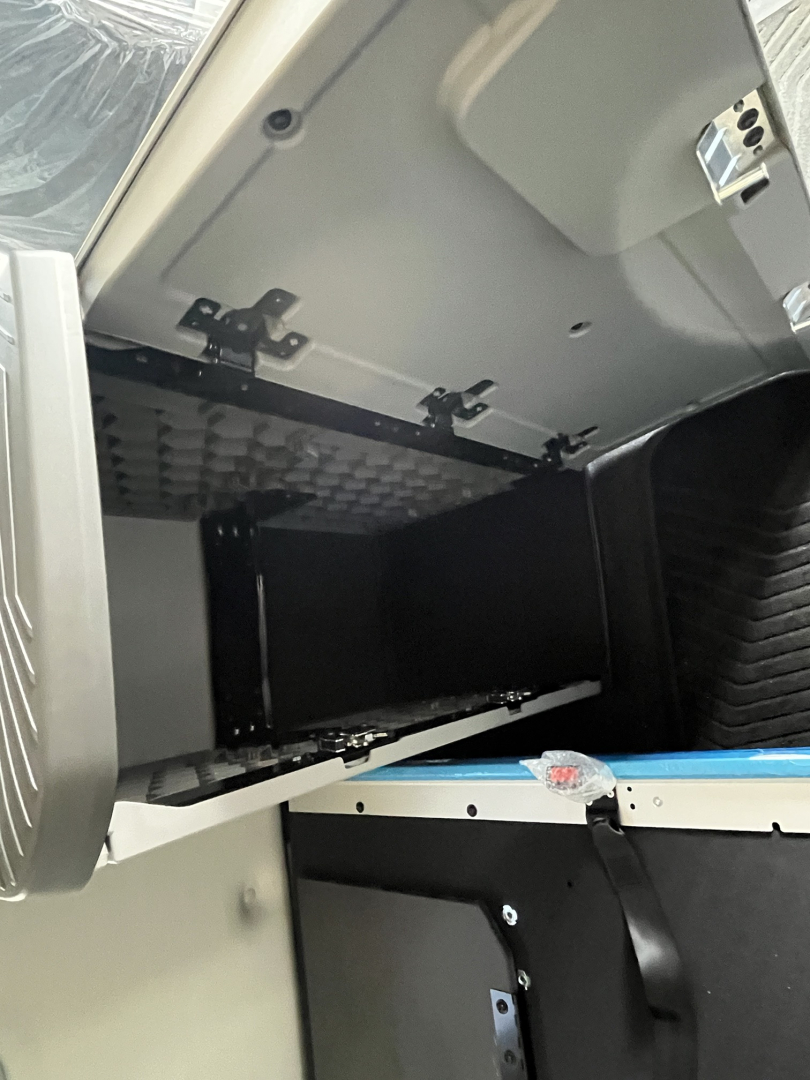  Volvo VNL64T840 sleeper cab interior showing open overhead storage compartments and interior panels.