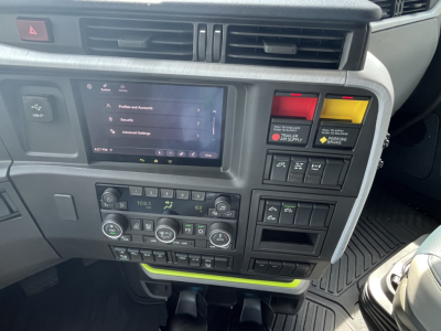 Volvo VNL64T840 dashboard and center console showing touchscreen infotainment and climate controls.