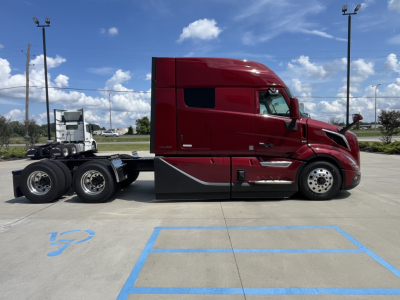 2026 Volvo VNL64T840 conventional sleeper truck side profile showing red cab and dual rear axles.