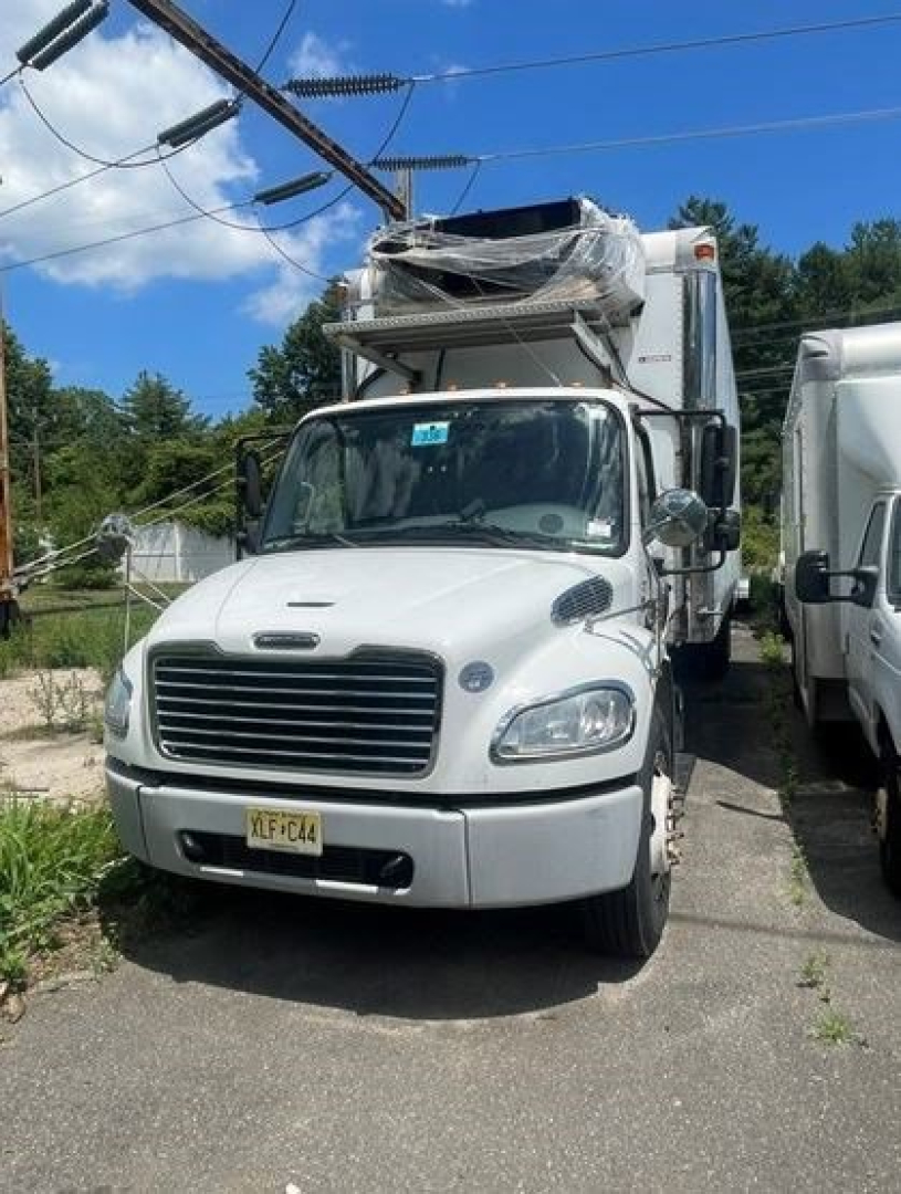 Medium-duty Freightliner M2 106 front view with cargo box, NY license plate, Reefer truck setup visible; VIN tag and stock number not visible.