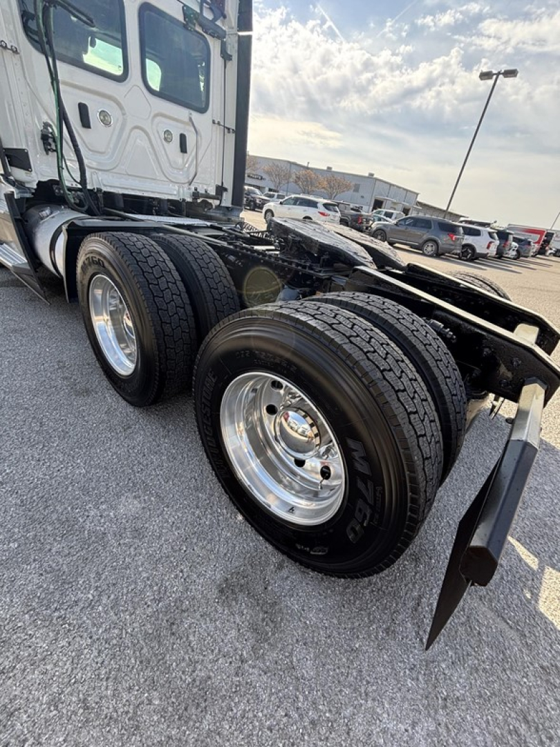 Freightliner Cascadia 126 truck rear dual axles showing wheels and frame, with stock and VIN details in listing
