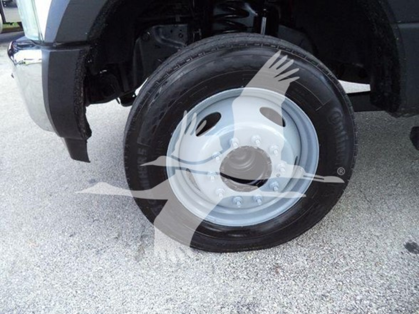 Ford F-550 front wheel and fender. Visible text: none besides wheel hub area, tire sidewall; no legible labels or serials in image.