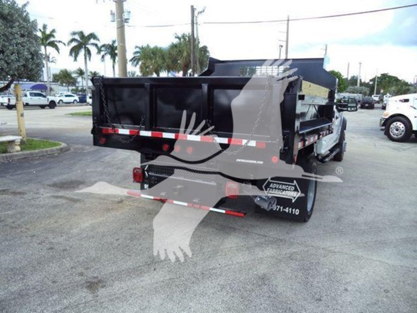 Dump truck bed of a 2018 Ford F-550 XL seen from rear, with black dump body, mudflaps, and reflective strips.