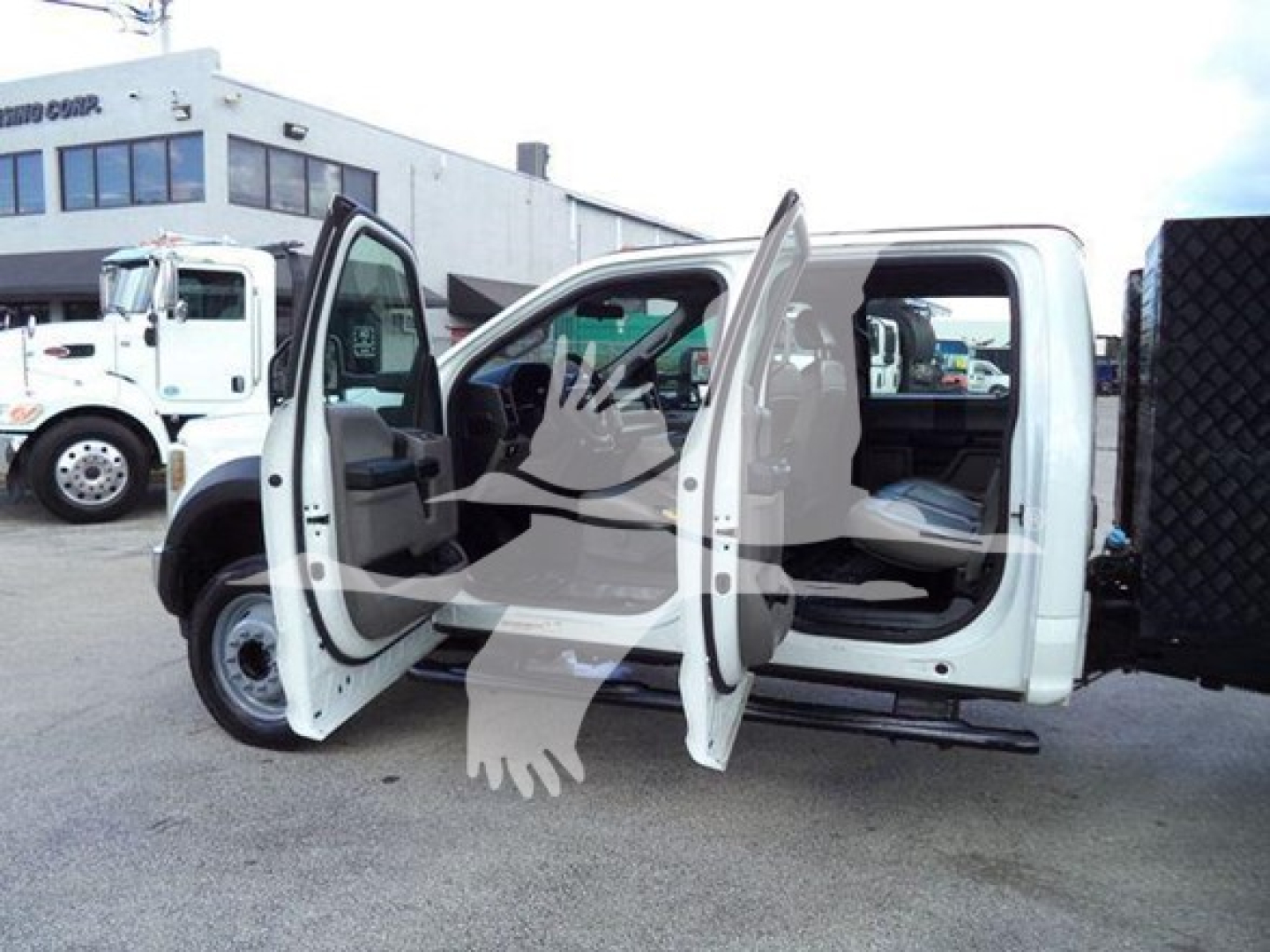 Ford F-550 XL dump truck cab with front and rear doors open, showing interior and side step rails.