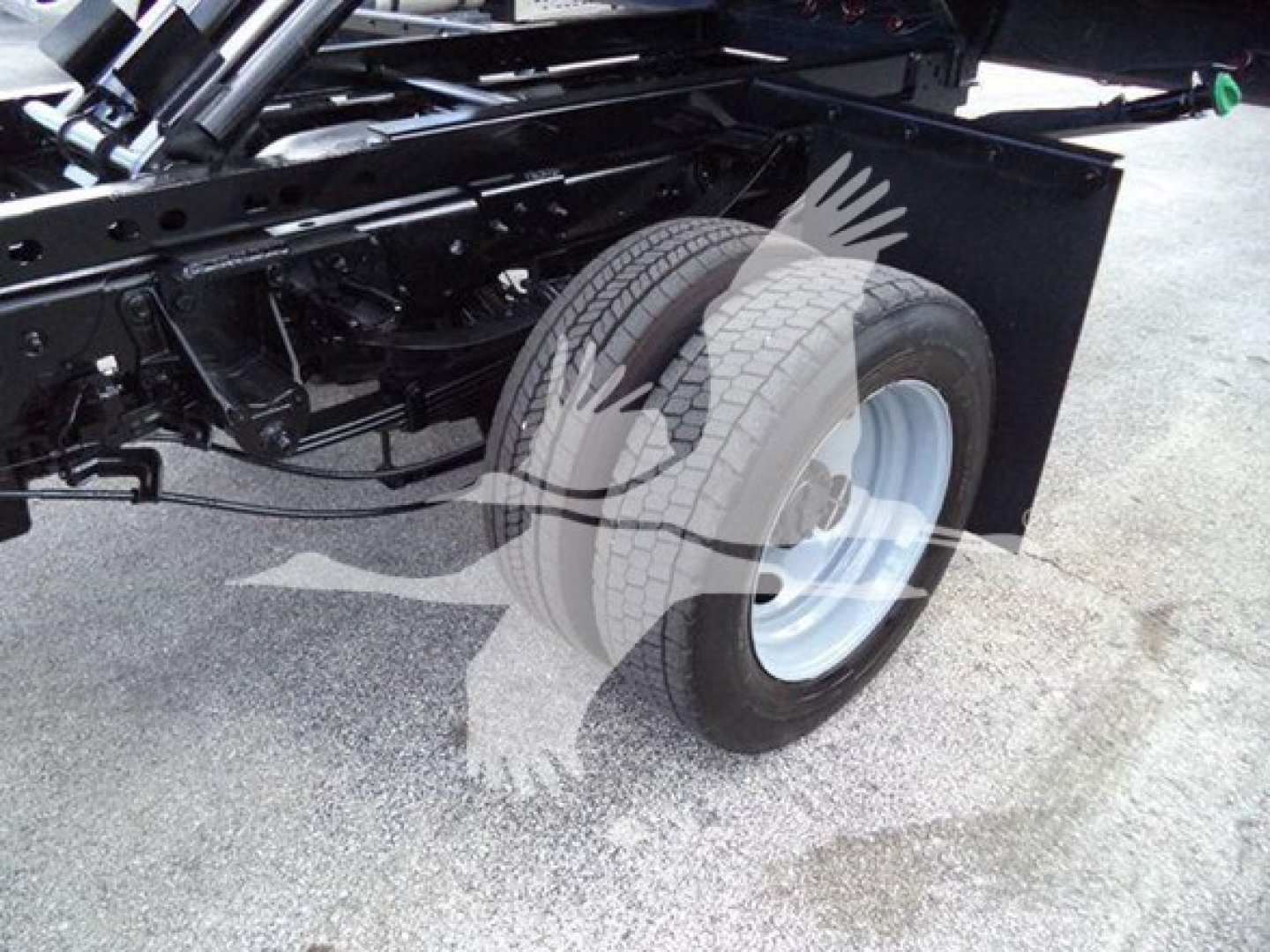 Truck chassis with rear wheel and suspension visible; no readable labels or fluid markings present.