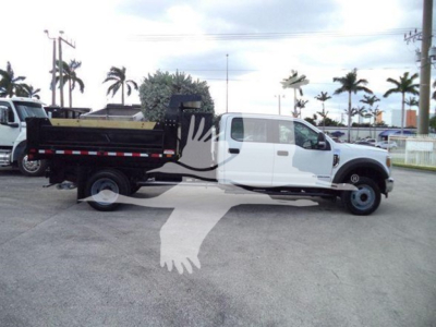 Ford F-550 dump truck in side view with white cab and black dump bed, visible VIN/EPA stock text overstamped by watermark