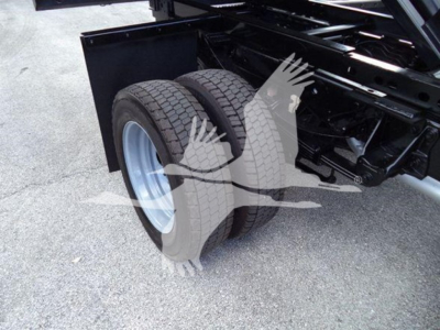 Dual rear tires on a Ford F-550 chassis showing wheel assembly and frame near the dump bed.