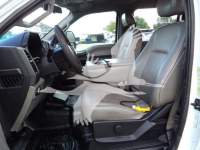 Ford F-550 XL cab interior showing front seats and dashboard view.