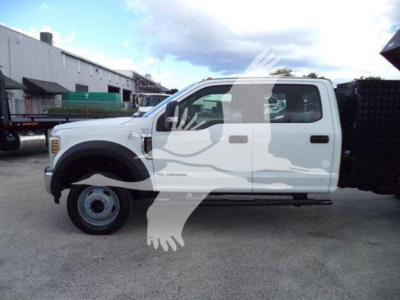 Ford F-550 XL dump truck side view showing cab and chassis with white paint and branding.