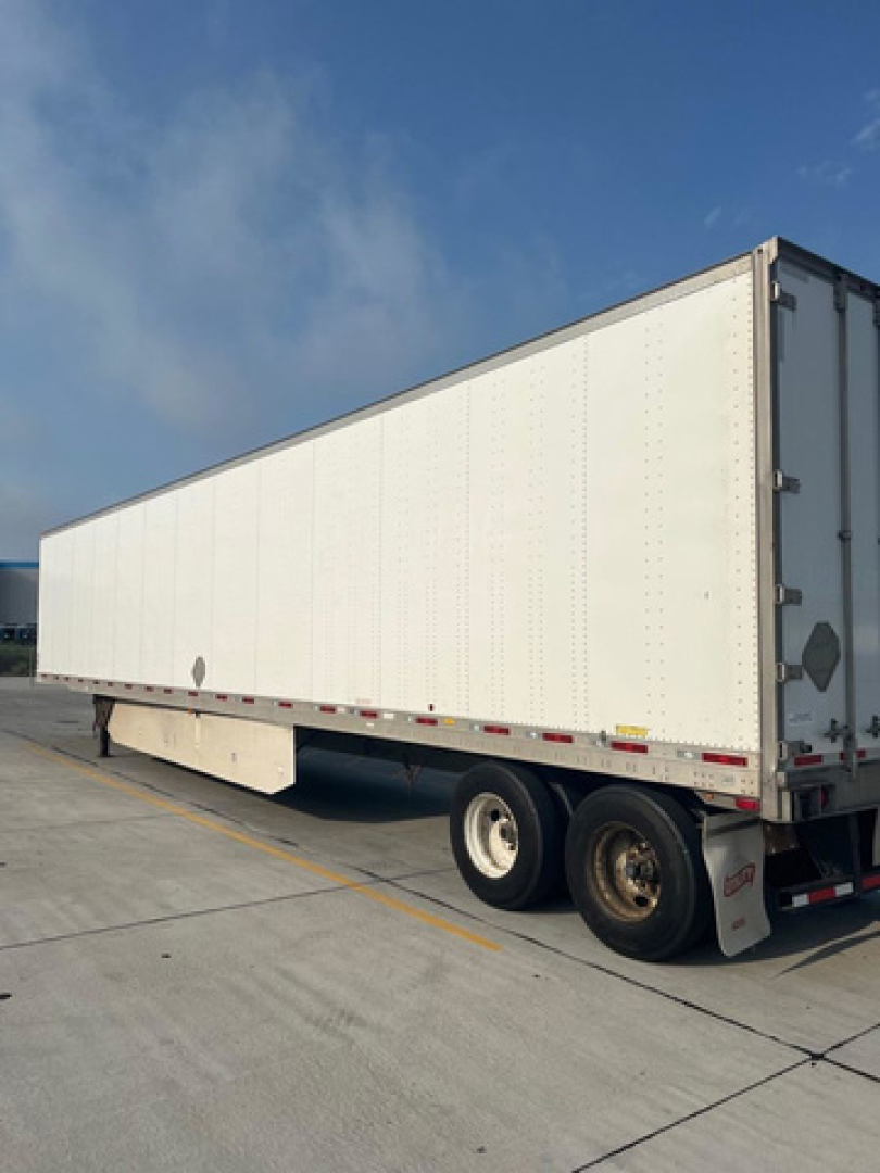 Utility van trailer showing white box trailer with dual rear axles and back doors.