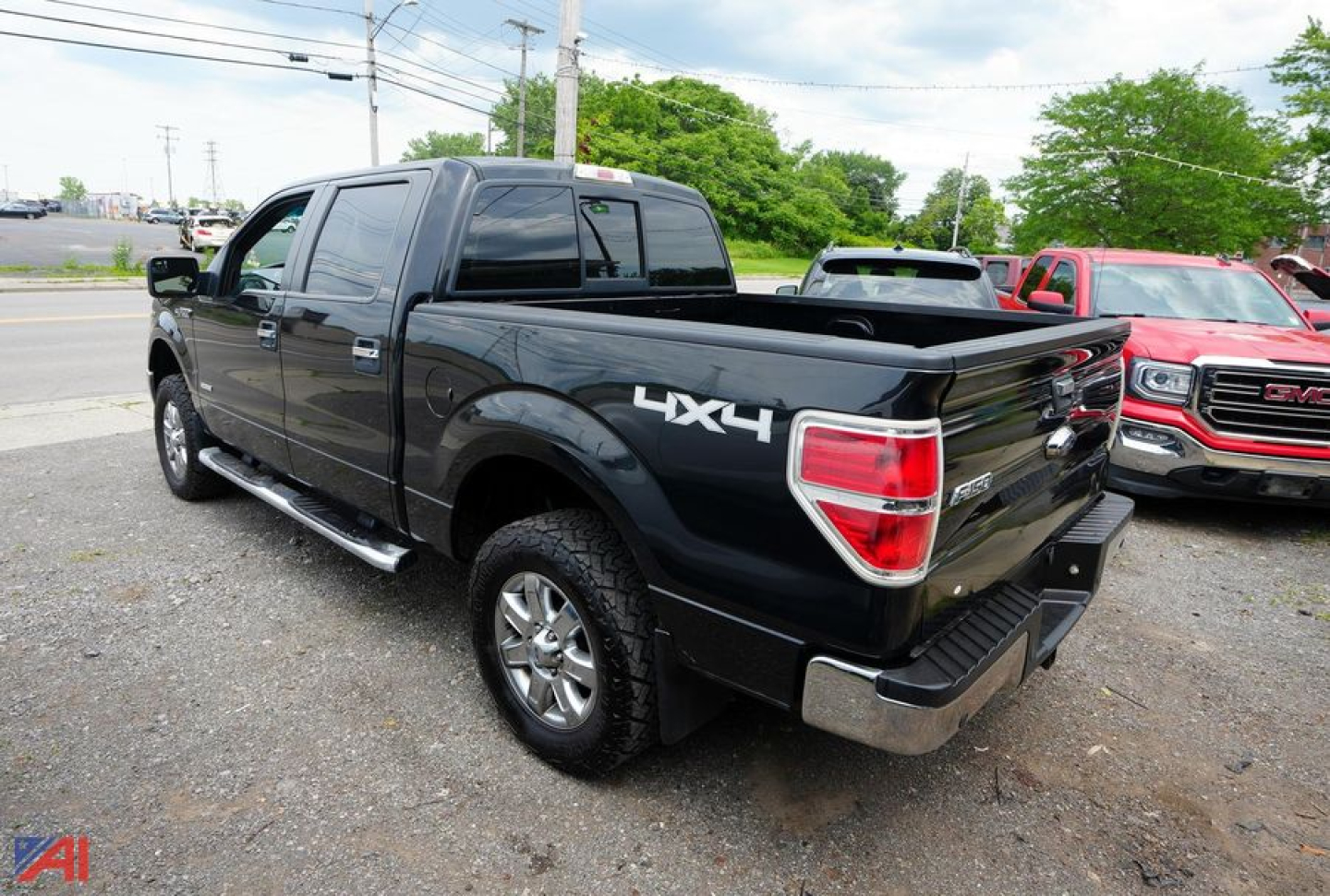 Ford F-150 XLT SuperCrew 4x4 pickup truck in black with LX4 badge on rear quarter panel, chrome exhaust, and bed rail cap.