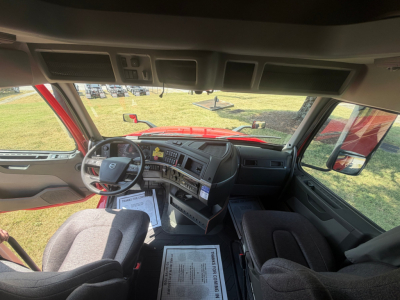 Volvo VNL64T760 truck cabin interior view from driver seat showing dashboard, steering wheel, and front seating area.