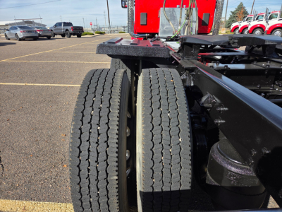 Dual rear tractor tires of a Kenworth T880 tractor chassis showing tread pattern and mounting hub.