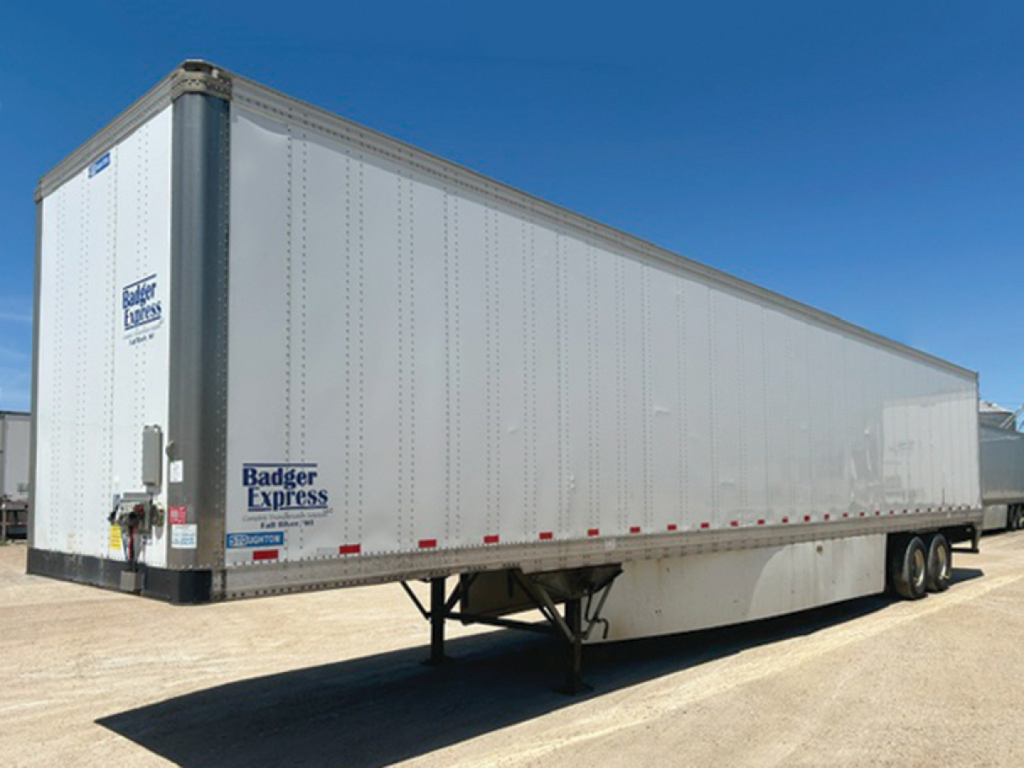 Trailer side view showing a 2019 Stoughton van trailer with Badger Express stickers and dual axles.