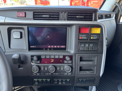 Truck cab dashboard and control panel of a Volvo VNL interior showing touchscreen display and climate controls
