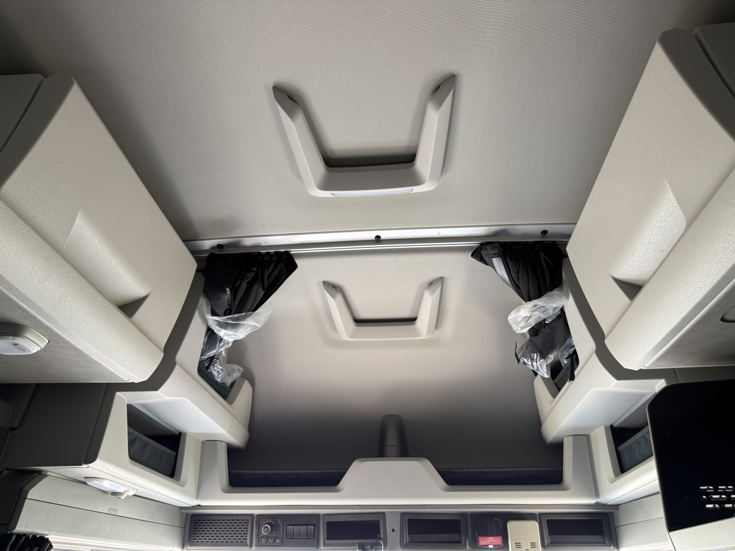 Interior overhead sleeper area of a Volvo VNL truck showing overhead storage compartments and ceiling panels.