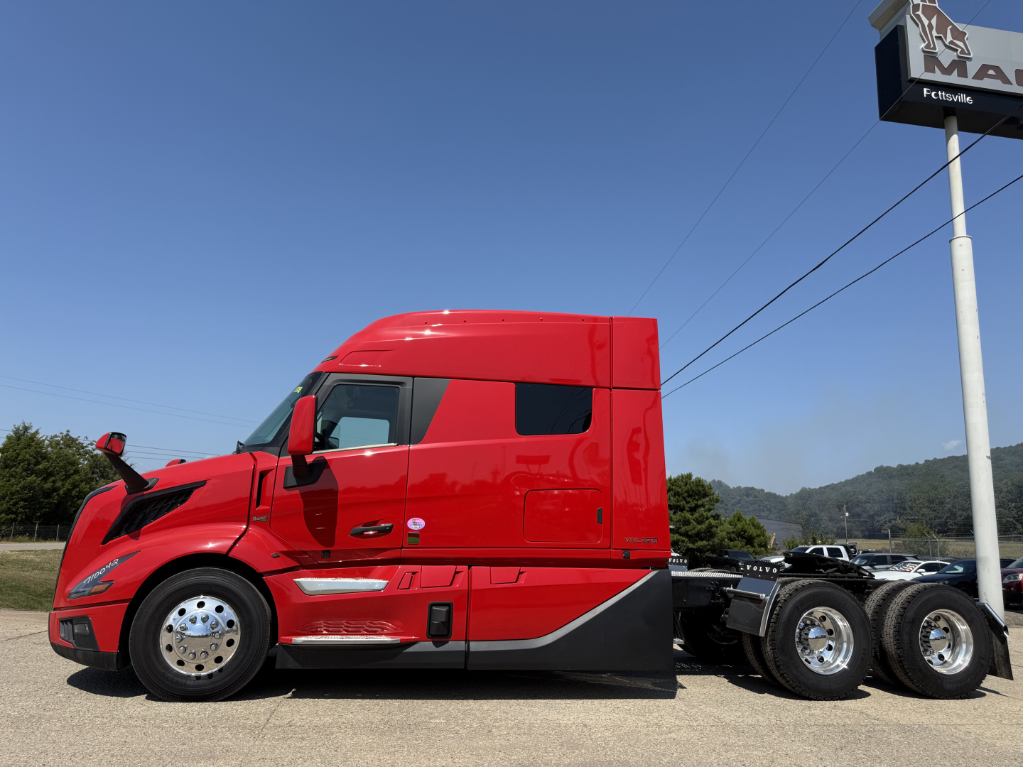 Volvo VNL64T840 side view showing cab and chassis with red paint and sleeper, no visible text.