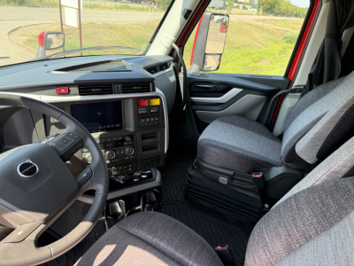 Volvo VNL64T840 truck interior showing steering wheel, dashboard, and driver seat with center console area.