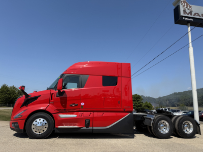Volvo VNL64T840 side view showing cab and chassis with red paint and sleeper, no visible text.