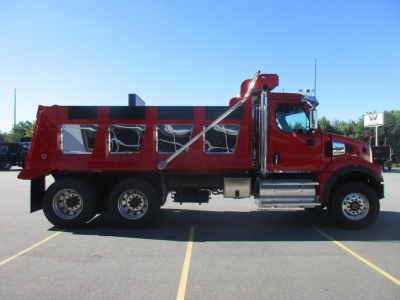 2027 Western Star 47X dump truck side view showing red cab, black-tinned dump body, chrome steps, and dual rear axles.