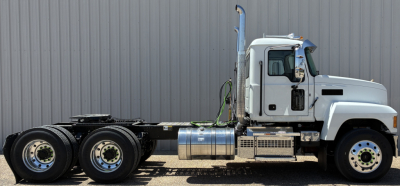 Truck chassis side view showing 10-wheel configuration with cab and fuel tanks.