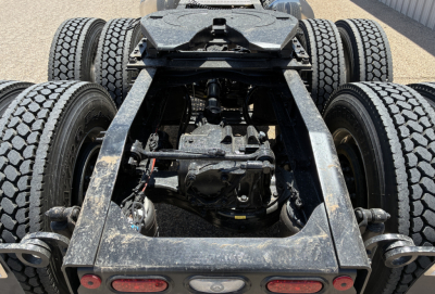 Mack PI64T chassis undercarriage showing rear dual axle suspension and drivetrain components with label text not visible.