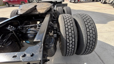 Kenworth T680 chassis with dual rear axles and tires visible, drivetrain and suspension components in view.