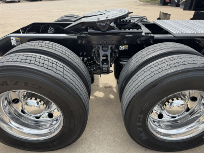 Peterbilt 579 chassis view showing dual rear axles and tires, chrome wheels, and fifth wheel area.