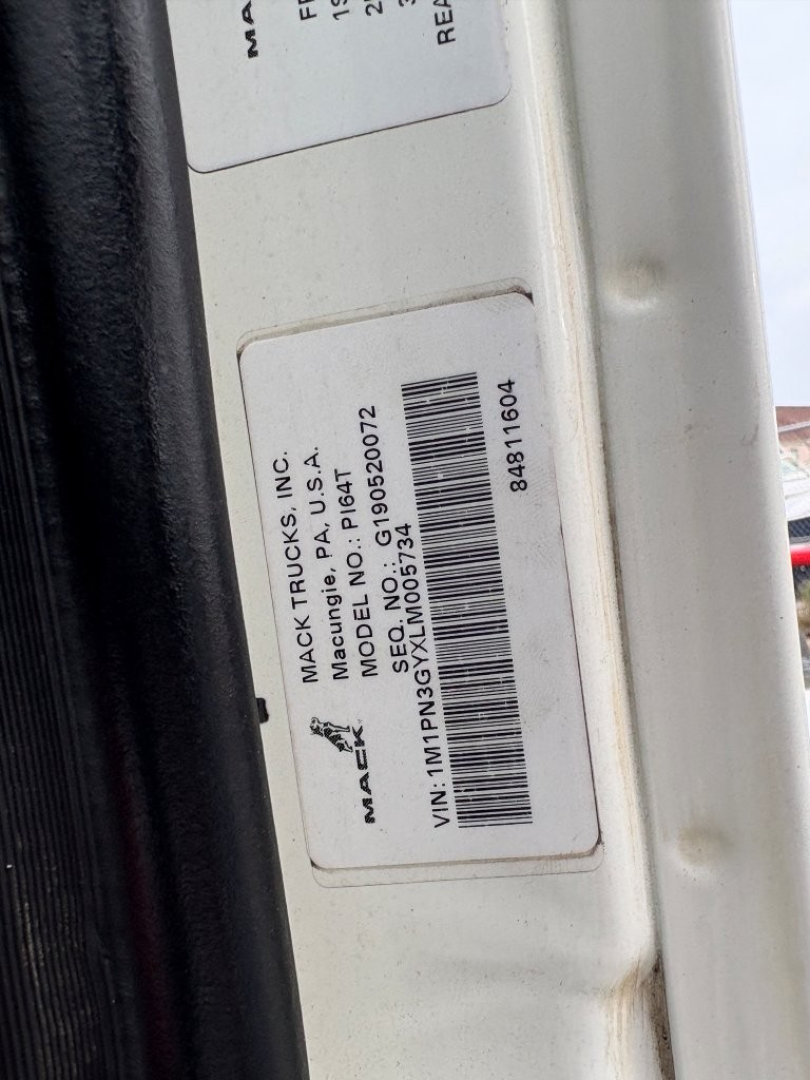 Mack Trucks label on door jamb: MODEL P1G? (likely PI64T) MADE IN USA, VIN: 1M... Lot/serial numbers and barcode visible.