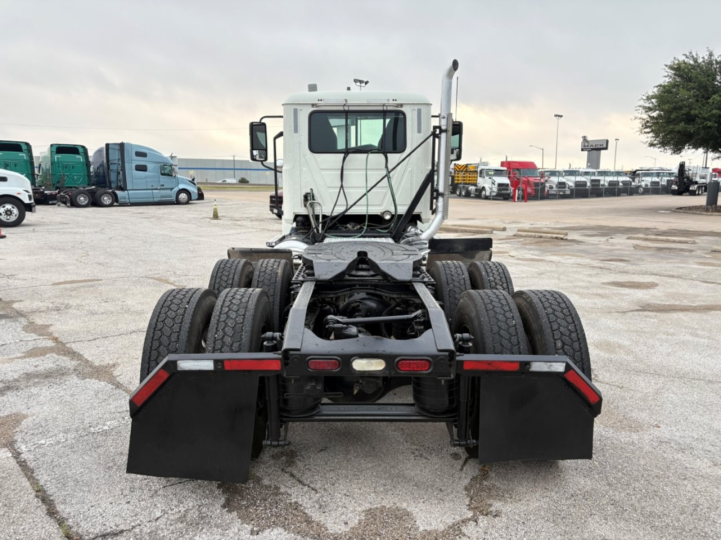 Mack PI64T chassis rear view showing dual rear axle configuration and mud flaps.