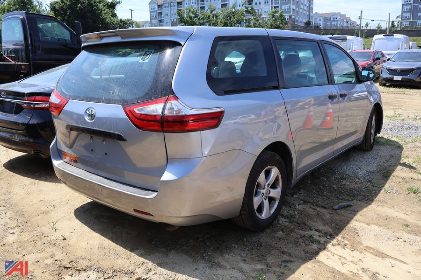 Toyota Sienna minivan rear three-quarter view showing tailgate and taillights.