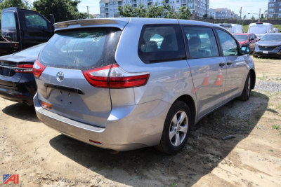 Toyota Sienna minivan rear three-quarter view showing tailgate and taillights.