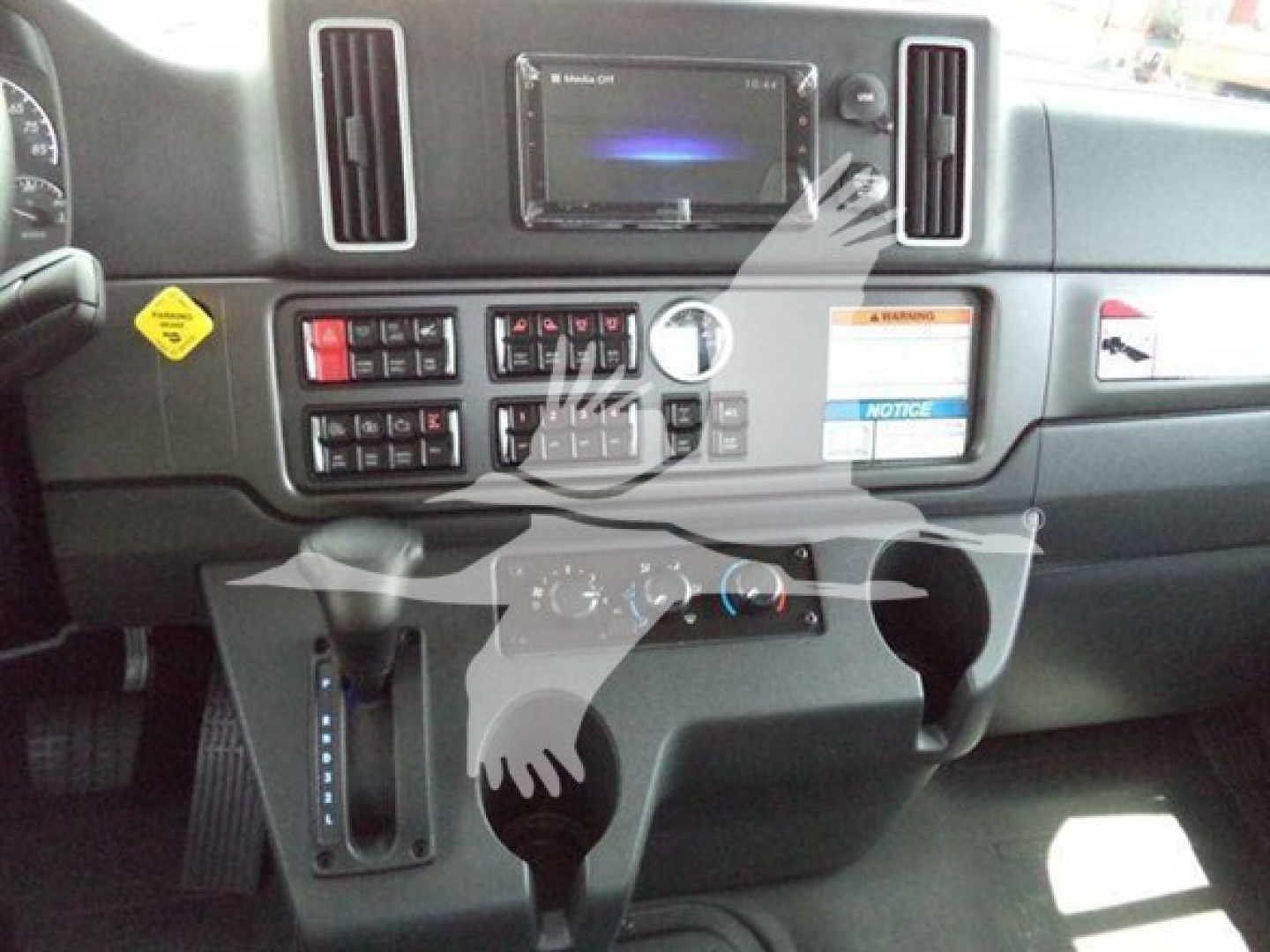 Dashboard of Freightliner M2 106 cab with center touchscreen display, control panels, and gear shifter visible.