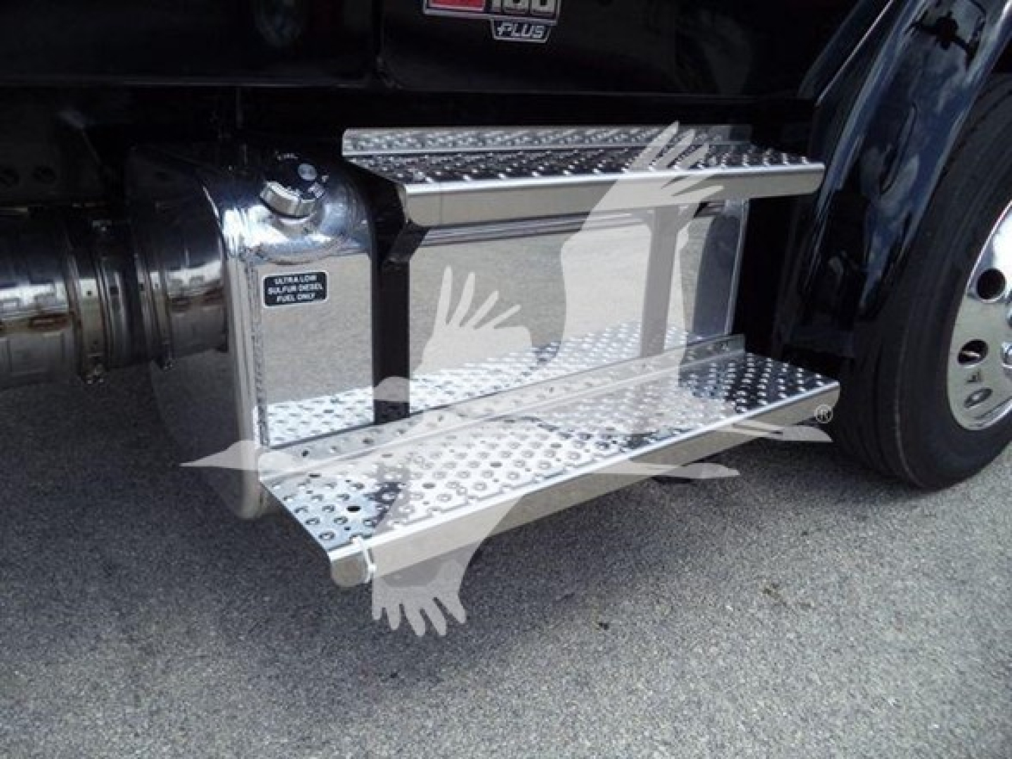 Freightliner M2 106 truck steps/side of cab with diamond plate retractable step shown and part of front wheel visible.