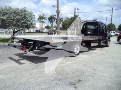 2027 Freightliner M2 106 rollback tow truck with flatbed and wheel-lift showing rear view and cab in background