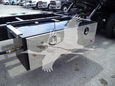 Freightliner M2 106 rollback truck body toolbox with metal storage box and hydraulic lines visible.