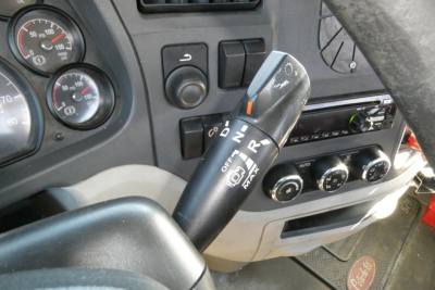 Peterbilt 579 interior view showing steering column with gear selector stalk, dashboard gauges, and climate controls.