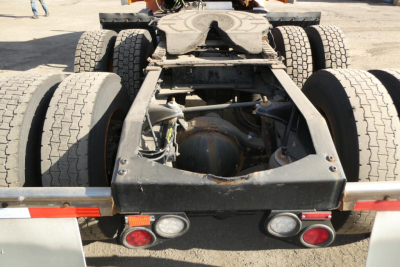 Peterbilt 579 rear chassis view showing fifth wheel, month tires, and rear lighting assembly.