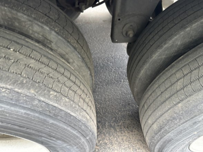 Trailer dual rear axle tires viewed from above. No visible text legible on tires or hub area.