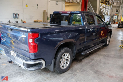Chevrolet Silverado 1500 Crew Cab pickup truck in a workshop showing rear and driver's side
