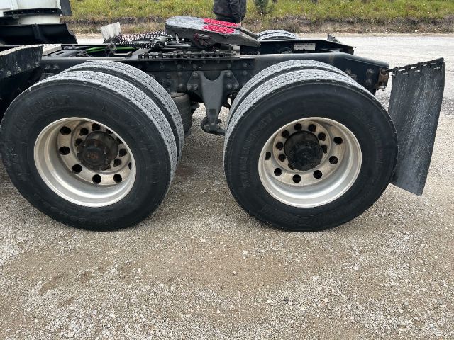 Trailer axles with dual rear wheels and mud flaps, 2019 International LT625 listing image showing wheel rims and tires.