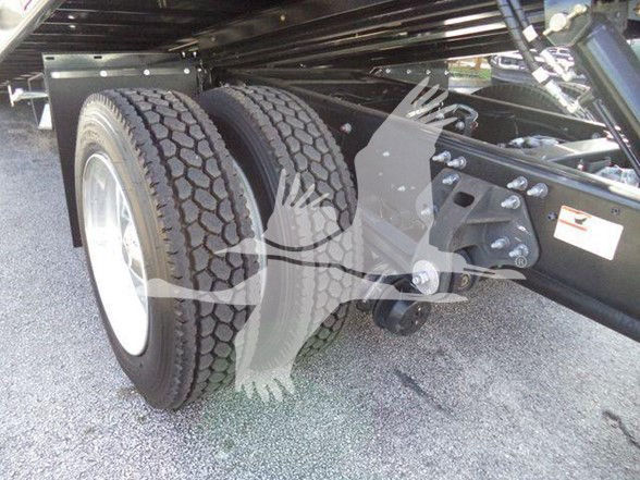 Dual rear wheels and chassis of a 2025 Hino 268A commercial truck showing wheel rims, tire treads, frame, and suspension components.