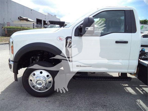 Ford F-550 truck side view showing front wheel, cab, and side mirror with VIN and stock number overlay in a dealership lot.
