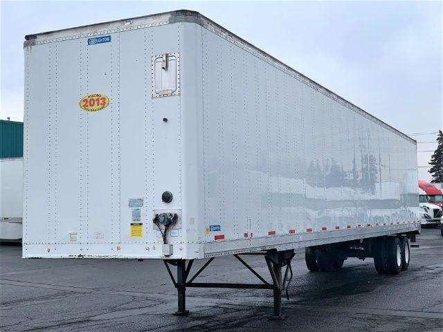 Stoughton 2013 dry van trailer, white exterior, raised legs, rear doors, VIN 6605 visible, side markers.