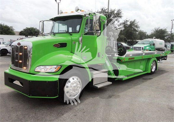 Green 2022 Peterbilt 337 tow truck with flatbed, front grille, and chrome mirrors; VIN 2NP2HM6XXNM762011 visible in listing context.
