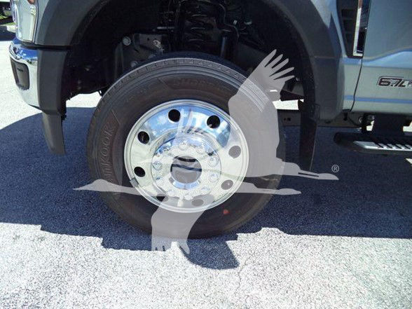 Ford F-600 XLT wheel and front suspension showing chrome hub, tire with Dunlop brand visible.