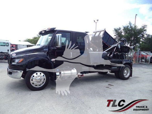 2025 International MV tow truck with dump bed, side view showing cab and chassis.
